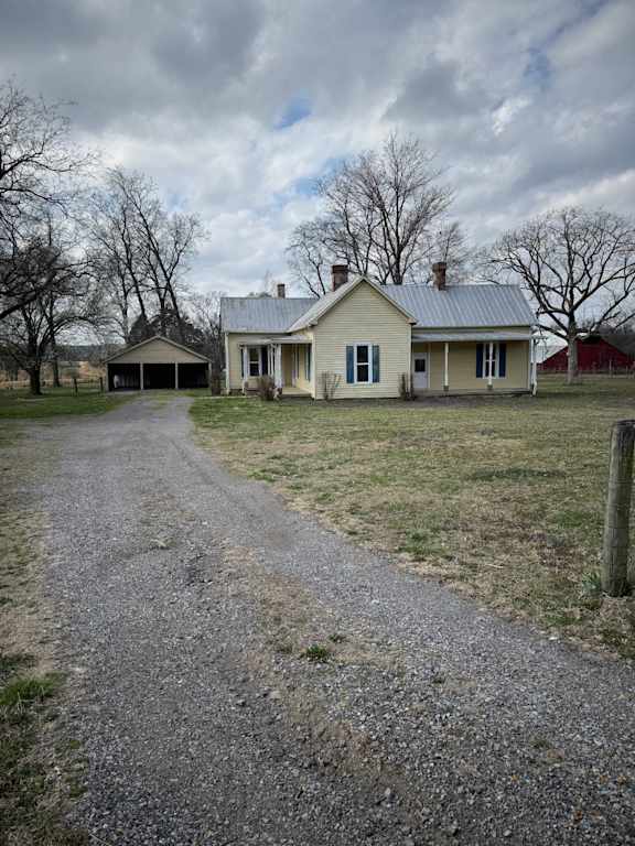 A house with a gravel driveway in front.