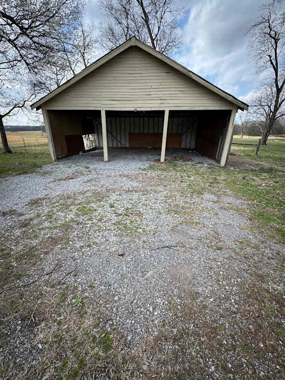 A small house with a grey roof is built into a hill.