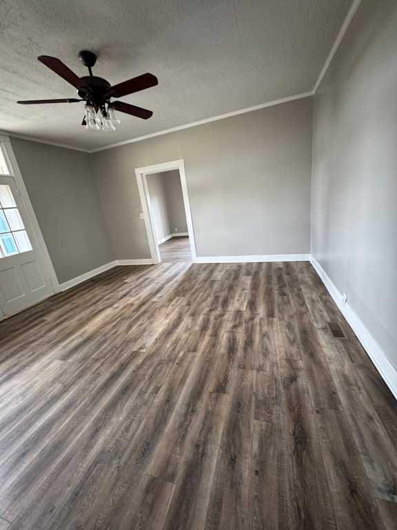 A room with a ceiling fan and a window.