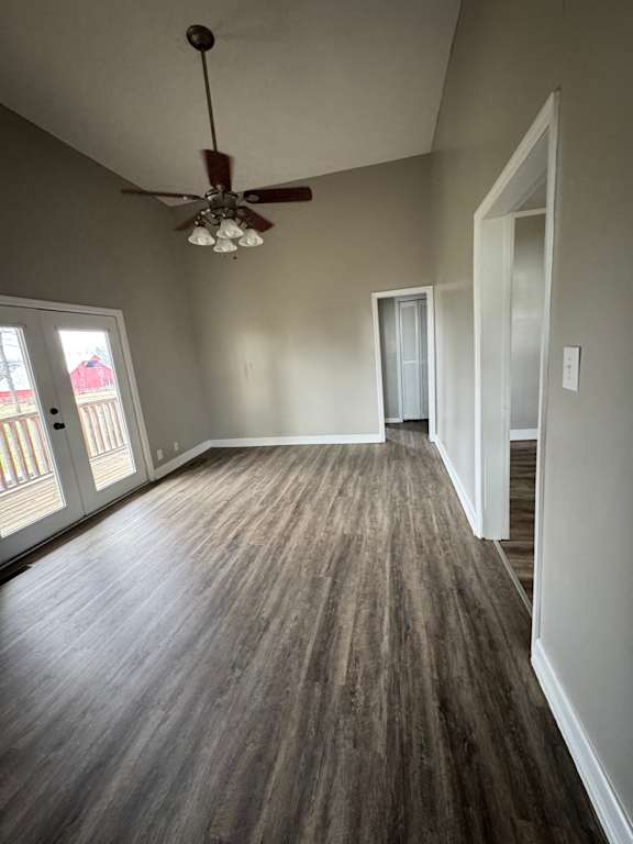 A room with a ceiling fan and a window with blinds.