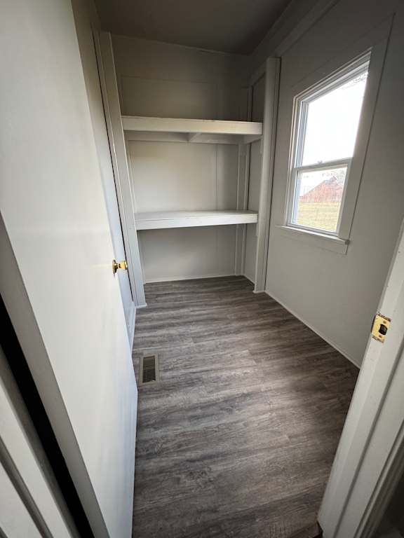 A room with a skylight and a grey wall.