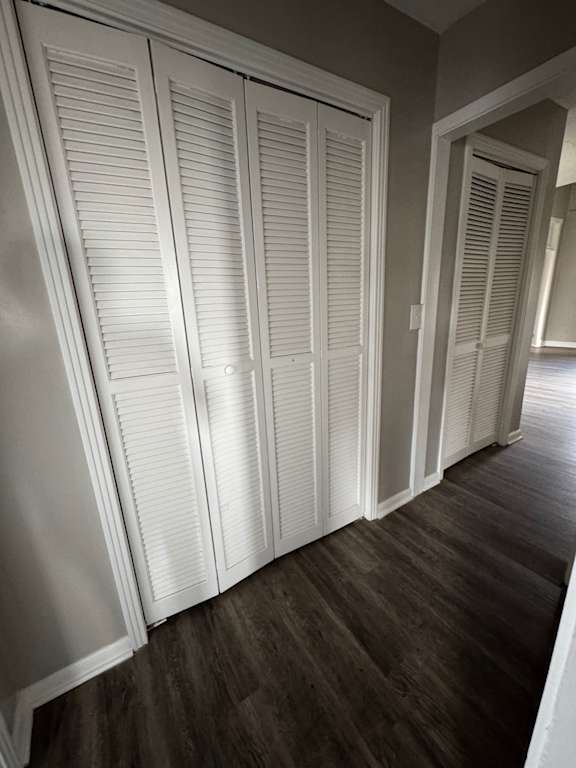 A set of white air vents on a wooden wall.