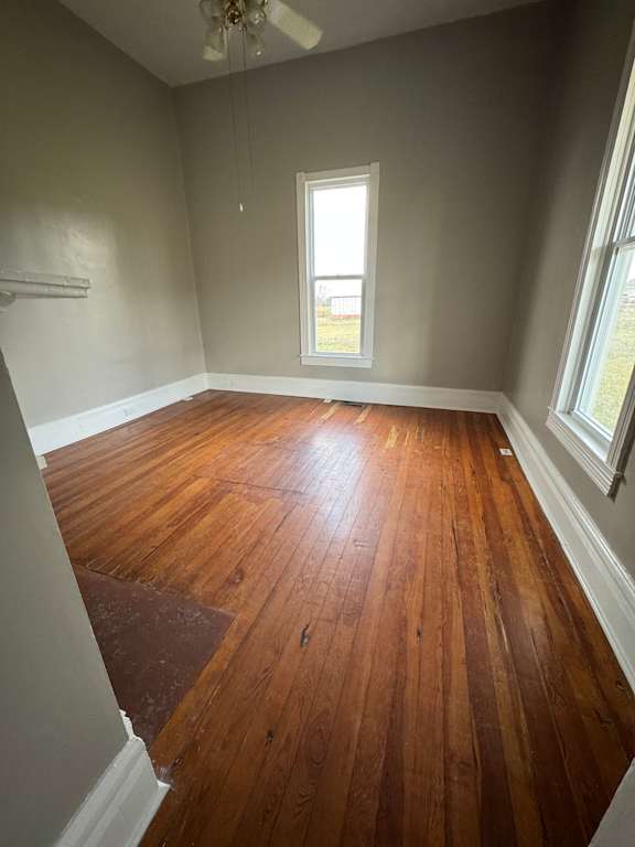 A room with a window and wooden walls.