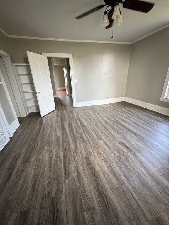 A room with a ceiling fan and a window.