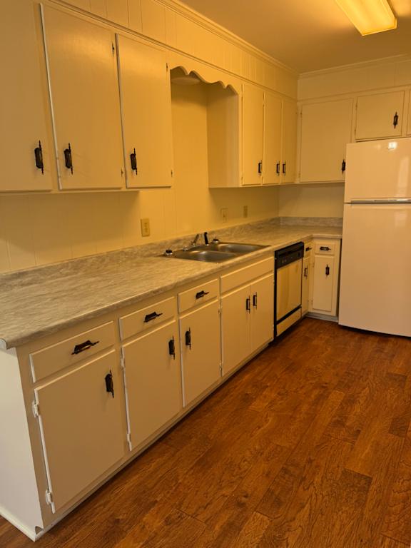 A kitchen with white cabinets and drawers.