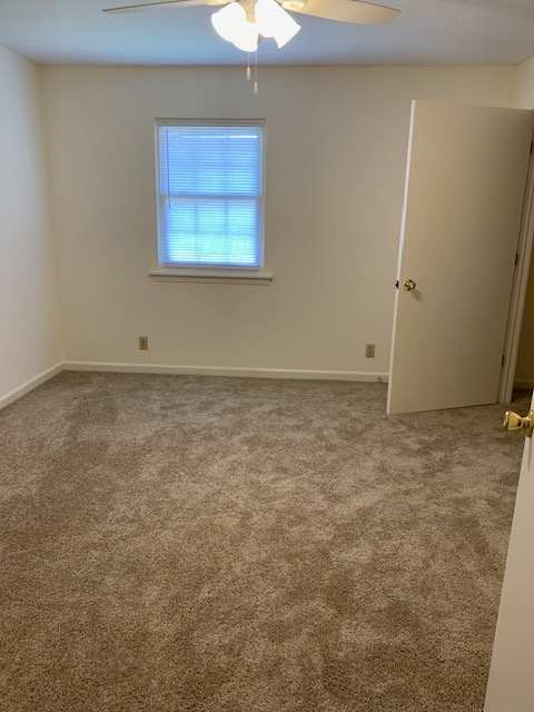 an empty bathroom with a window in the wall