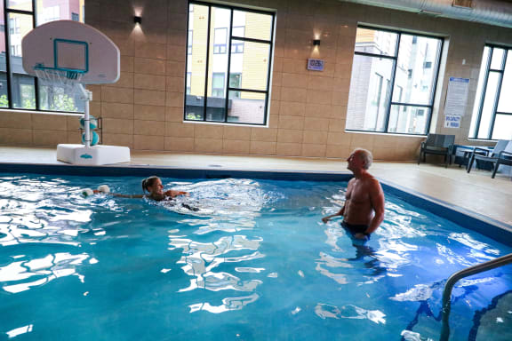 a man and a child in a swimming pool at Bluestone Flats, Duluth, MN