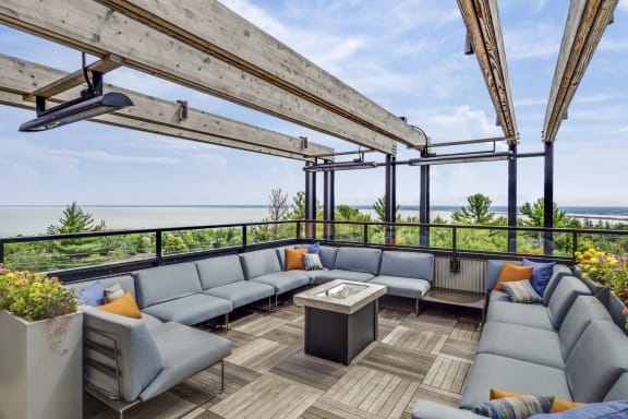 a rooftop patio with couches and a table at Bluestone Flats, Duluth, MN, 55803