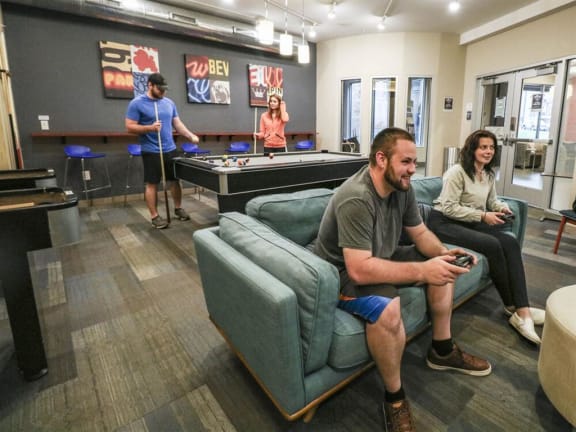 a group of people playing video games in a living room at Bluestone Lofts, Duluth, MN, 55803