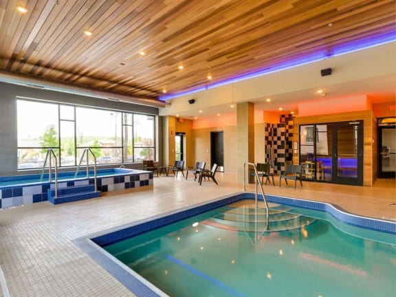a swimming pool in the middle of a building with a wood ceiling at Bluestone Lofts, Duluth