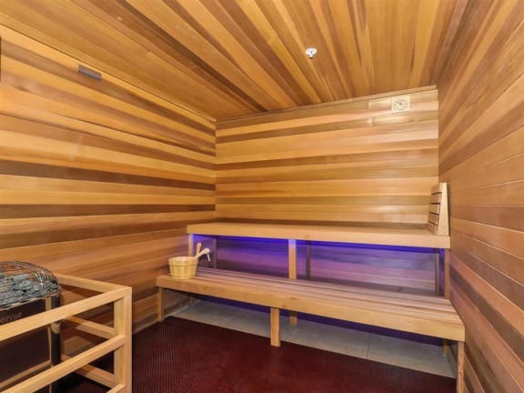 a small sauna with a bench and a bucket at Bluestone Lofts, Duluth, MN, 55803