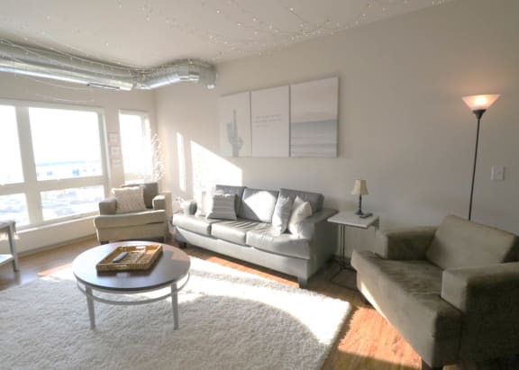 a living room with a couch and a coffee table at Bluestone Lofts, Duluth, MN