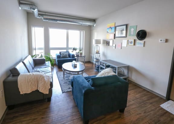 a living room with couches and a table at Bluestone Lofts, Minnesota, 55803