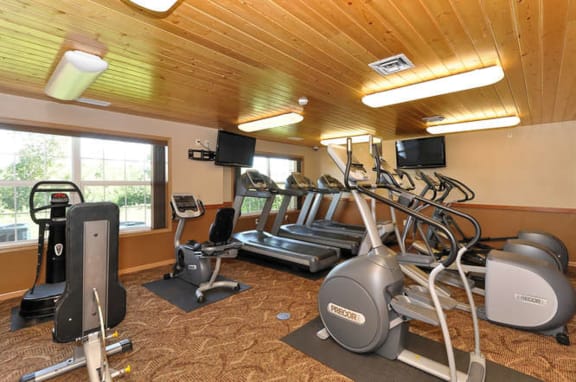a gym with various exercise equipment and a window at Summit Ridge, Duluth, MN, 55811