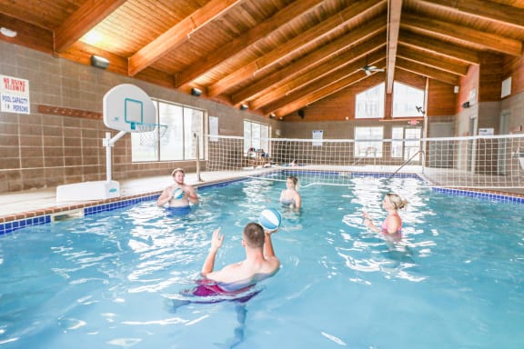 a group of people in a swimming pool playing with a frisbee at Summit Ridge, Duluth, MN
