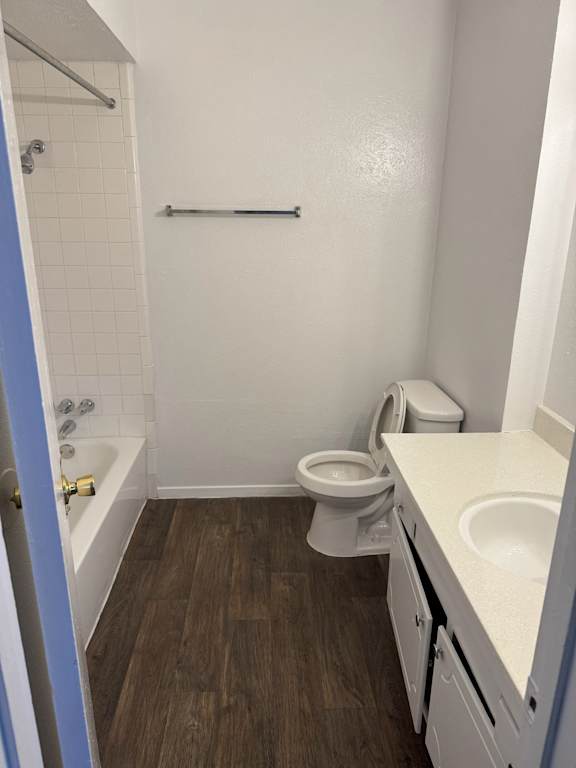 A small bathroom with a toilet, sink, and bathtub.