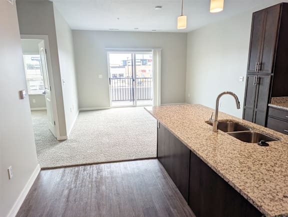 A kitchen with a sink and a counter top.