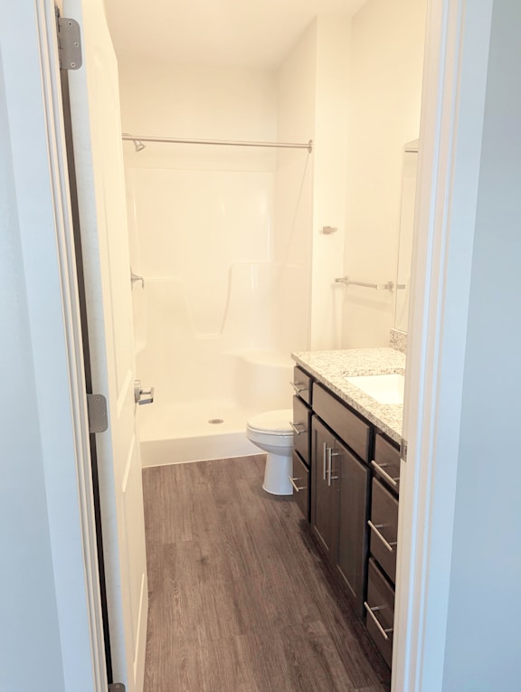 Bathroom with bathtub, shower surround, vanity, sink, mirror and vinyl flooring at Heartland Flats North Platte.