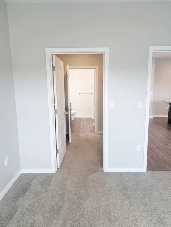 A white door is open to a hallway.
