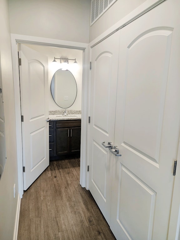 A white door with a mirror above it.