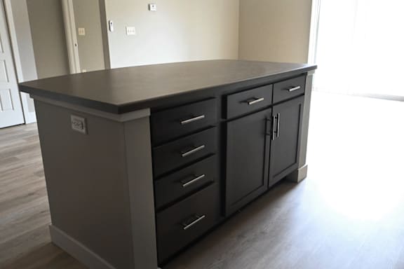 A kitchen island with drawers and cabinets.