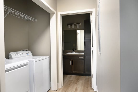 A white washing machine and dryer in a laundry room.