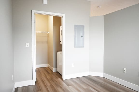 A room with a white door and a white wall.