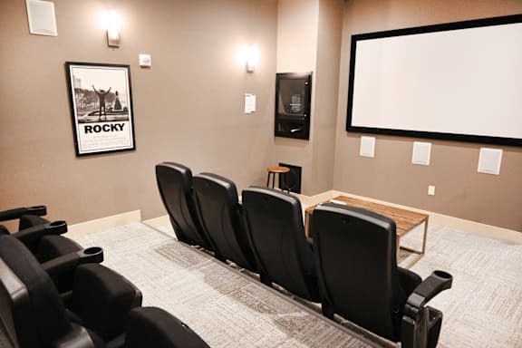 A room with a row of chairs and a poster on the wall.