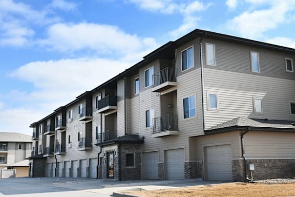 Apartment building with balconies and garages.