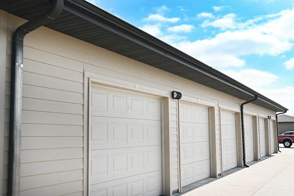 A row of white garage doors are closed.