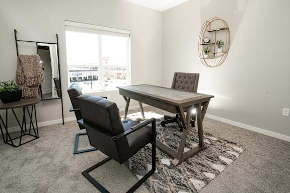 A room with a table and chairs in it.