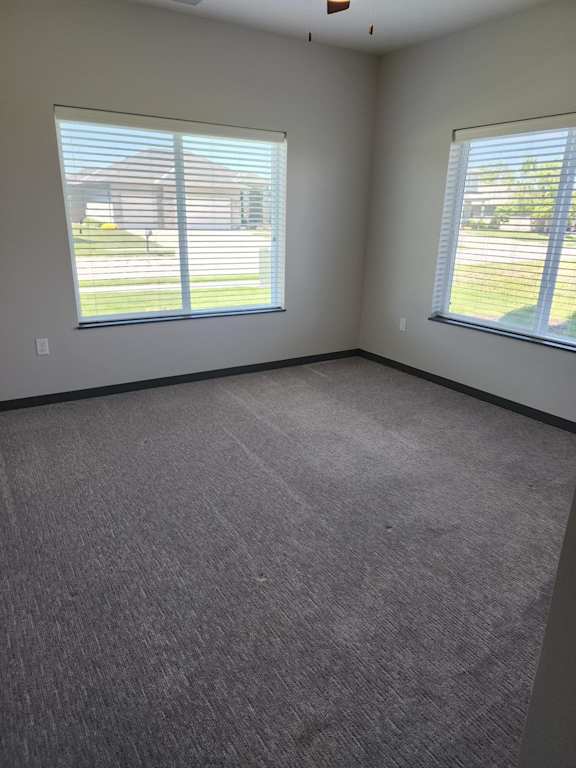 Bedroom with carpet flooring and two windows at The Harbor