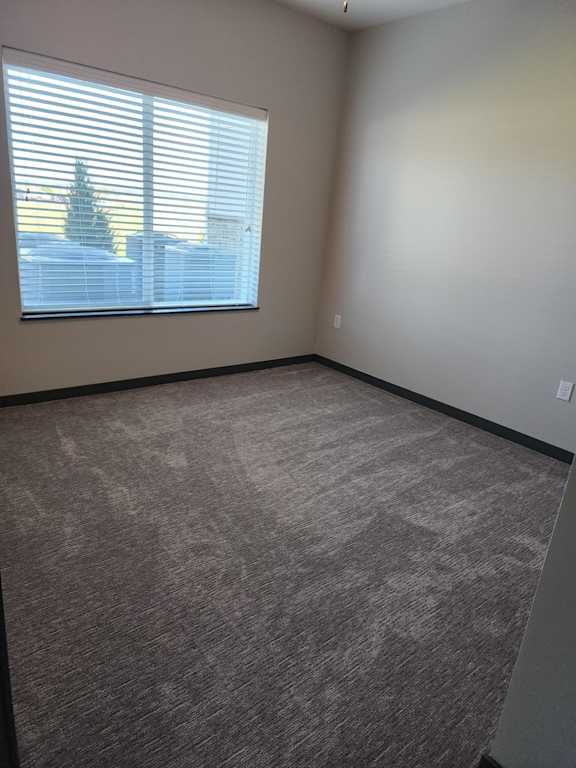Bedroom with carpet flooring and a single window at The Harbor