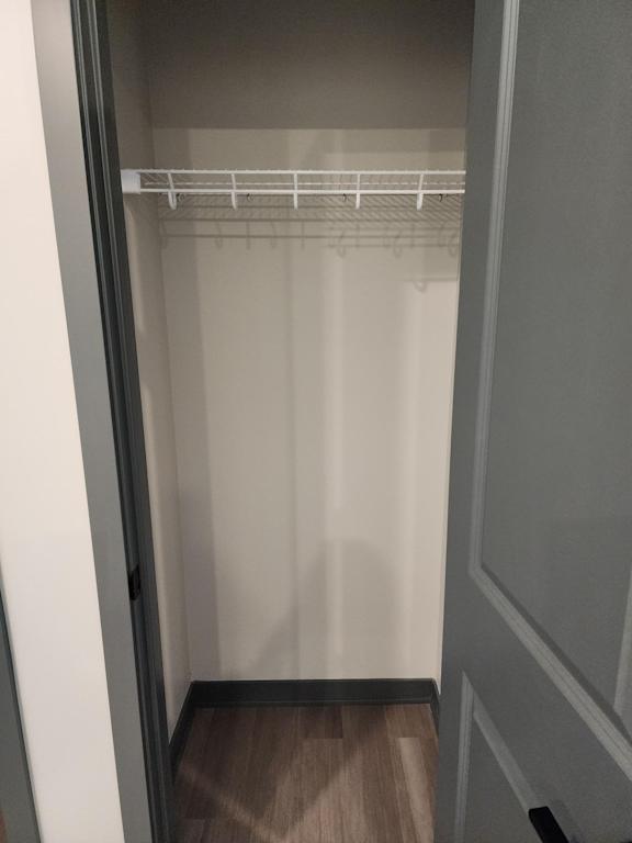 Closet with hanging rods and shelf storage at The Harbor