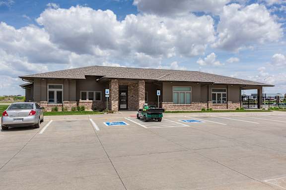 A furnished clubhouse lounge with seating areas at The Sterling at Grand Island.