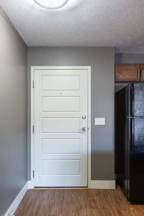 A hallway view with a closed interior door in the Durham home at The Sterling at Grand Island.
