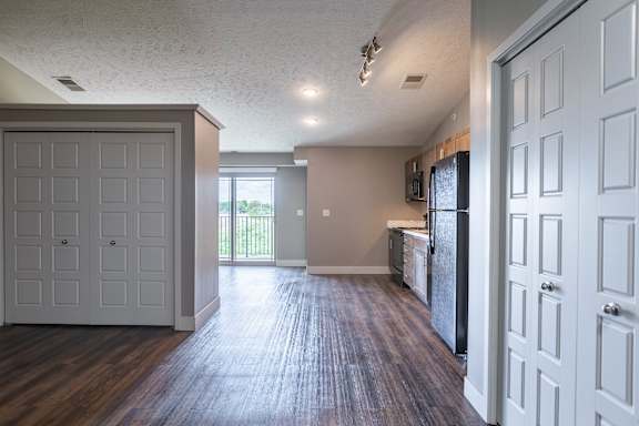 Open living area with wood flooring and a view of the kitchen