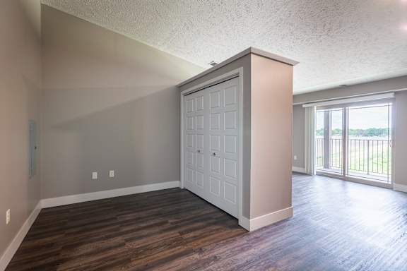 Closet wall with sliding doors next to a bright window