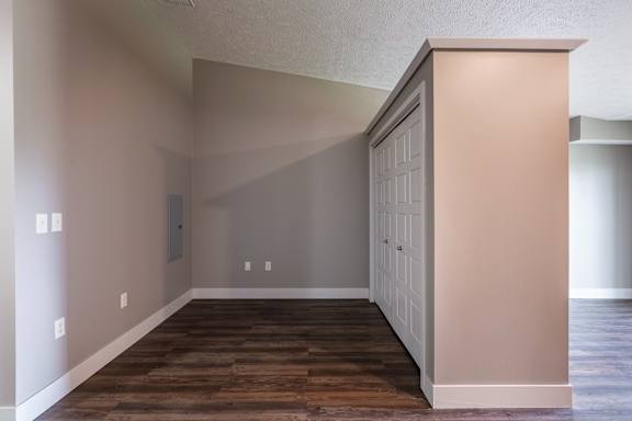 Bedroom space with a large closet wall and wood flooring