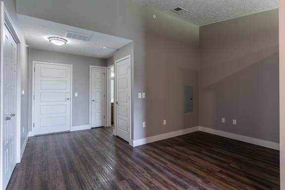Living area with wood flooring and a view toward the entry hallway