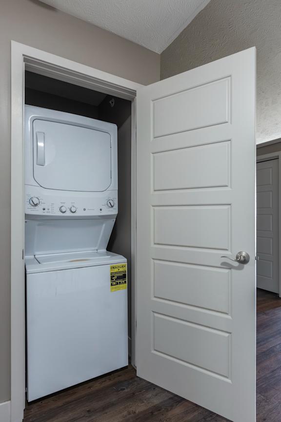 Laundry closet with a stacked washer and dryer