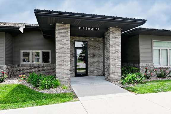 Exterior entrance of the clubhouse building with stone accents at The Sterling at Kearney