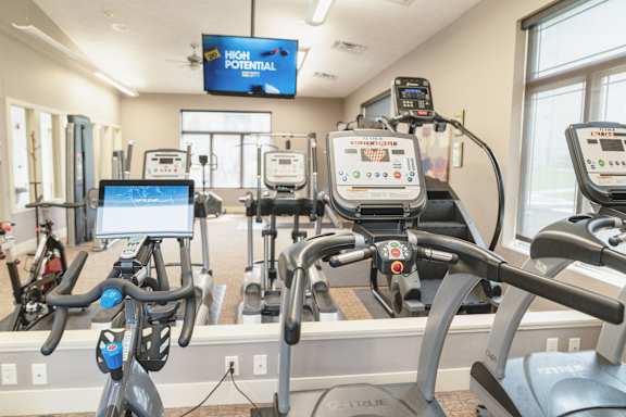 Fitness center with cardio equipment and weights at The Sterling at Kearney