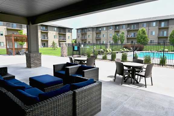 Covered outdoor patio with seating and tables at The Sterling at Kearney