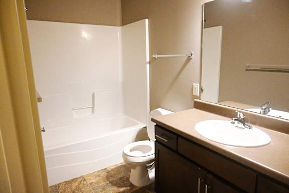 Bathroom with single sink vanity and bathtub at The Sterling at Kearney