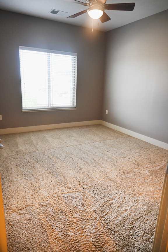 Bedroom with carpet flooring and a window at The Sterling at Kearney