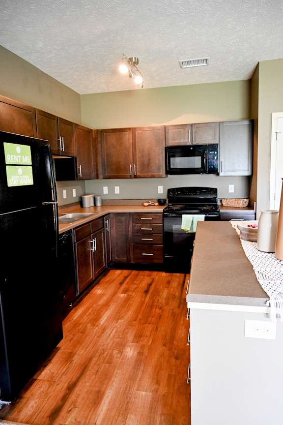Kitchen with refrigerator stove and sink in a corner layout at The Sterling at Kearney