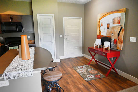 Furnished living area with chairs and hardwood style flooring at The Sterling at Kearney