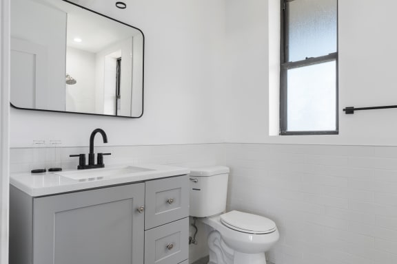 an all white bathroom with a white toilet and a sink