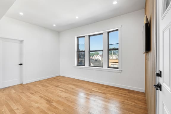 a living room with a wood floor and a window